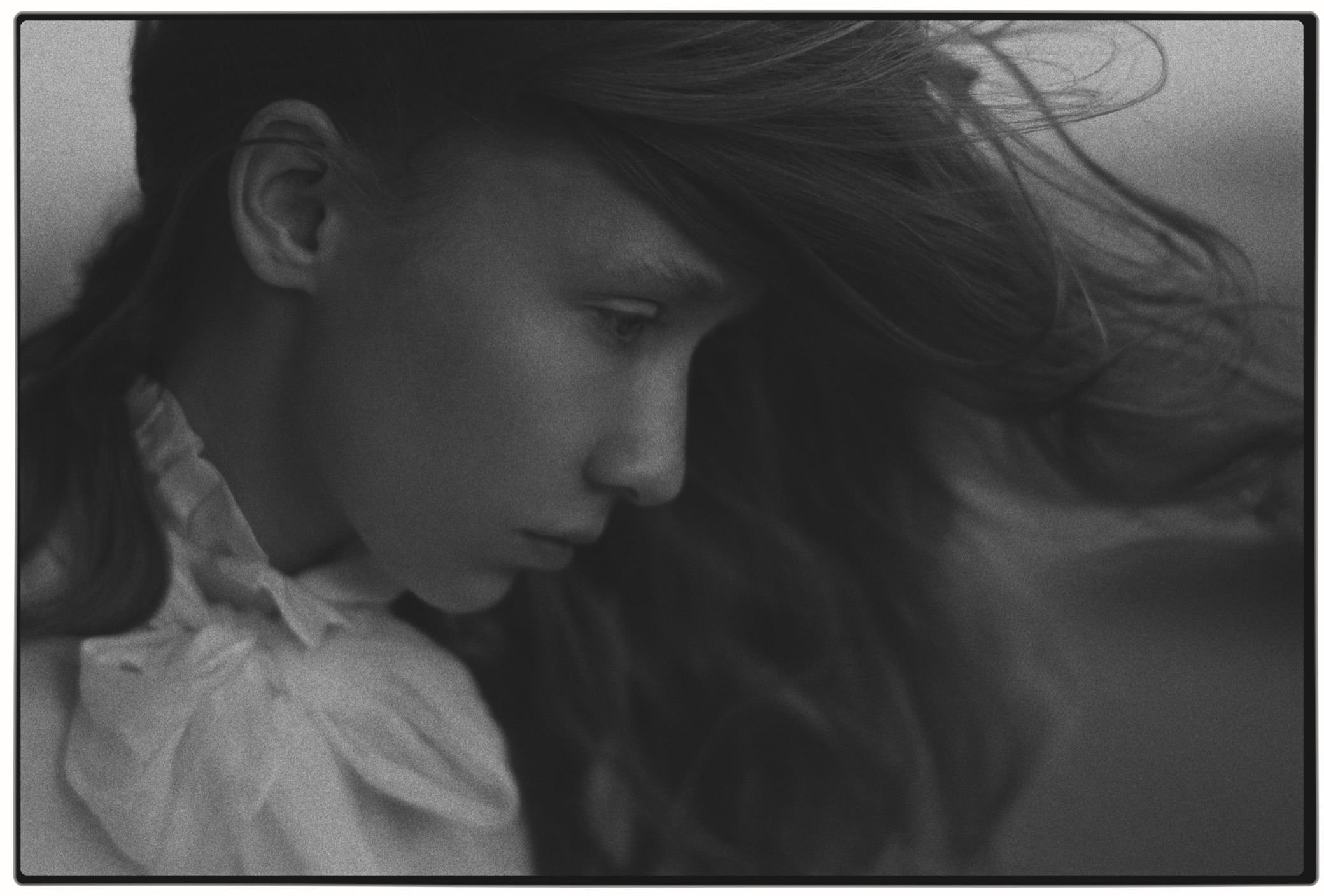 A portrait of a girl on Tri-X 400: a print with the film rebate, coarse grain